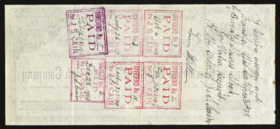 Backside shows a handwritten note and multiple colored stamps